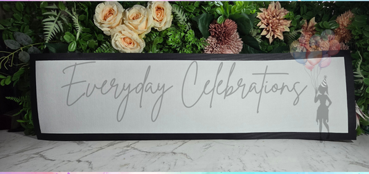 Decorative sign with 'Everyday Celebrations' text and floral design on a colorful watercolor background.